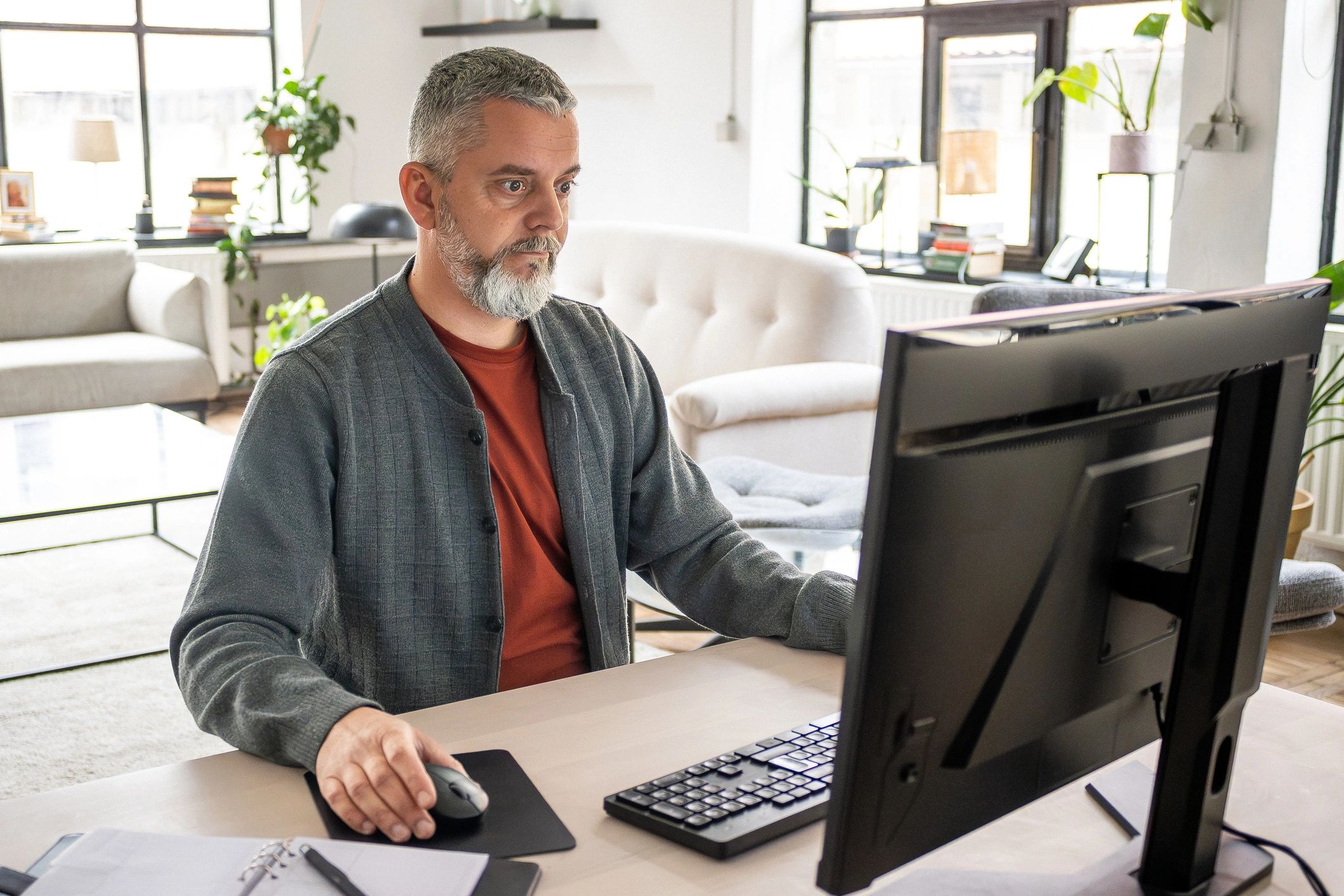 Pastor working thoughtfully at a desk in a quiet office